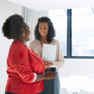 two black women in an office talking
